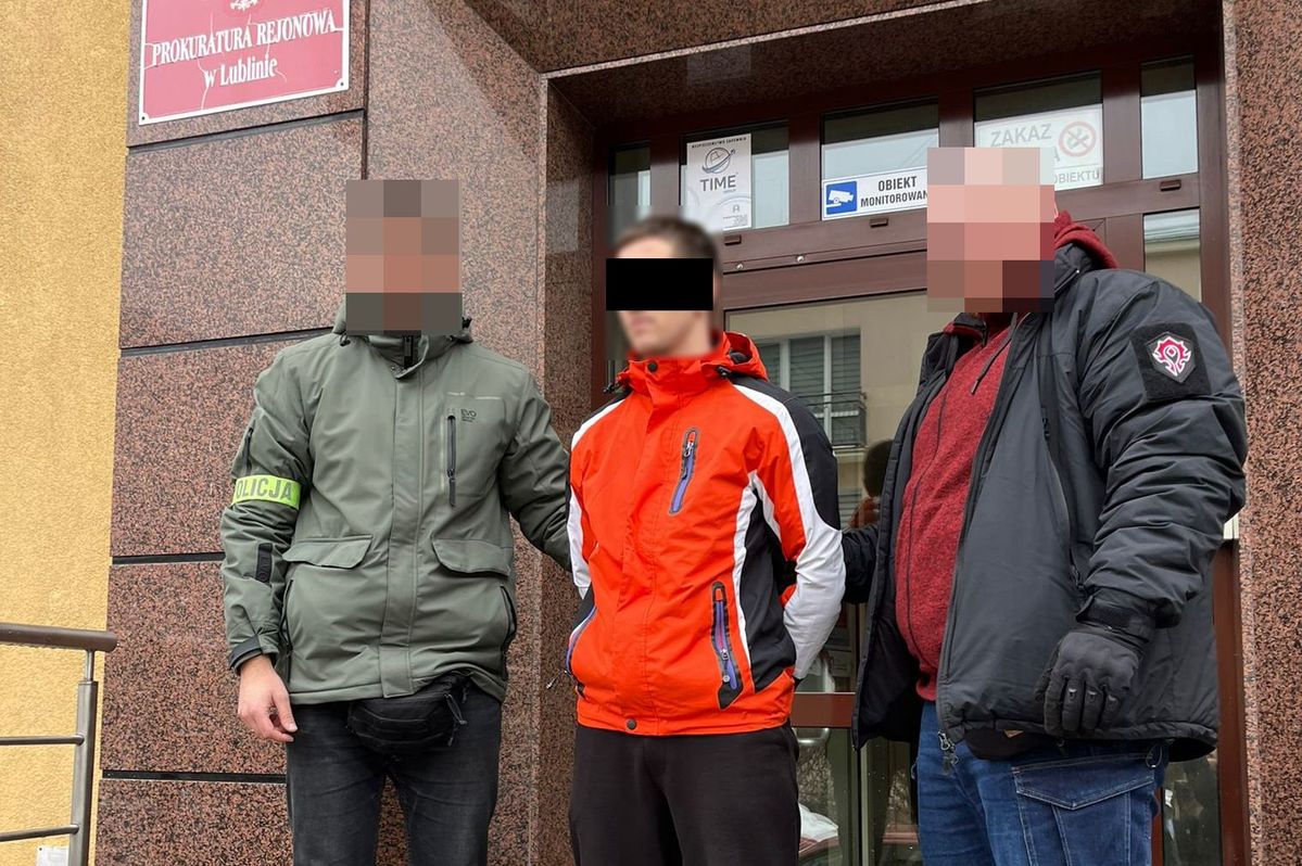 Policjanci wyprowadzają zatrzymanego mężczyzne z budynku prokuratury.