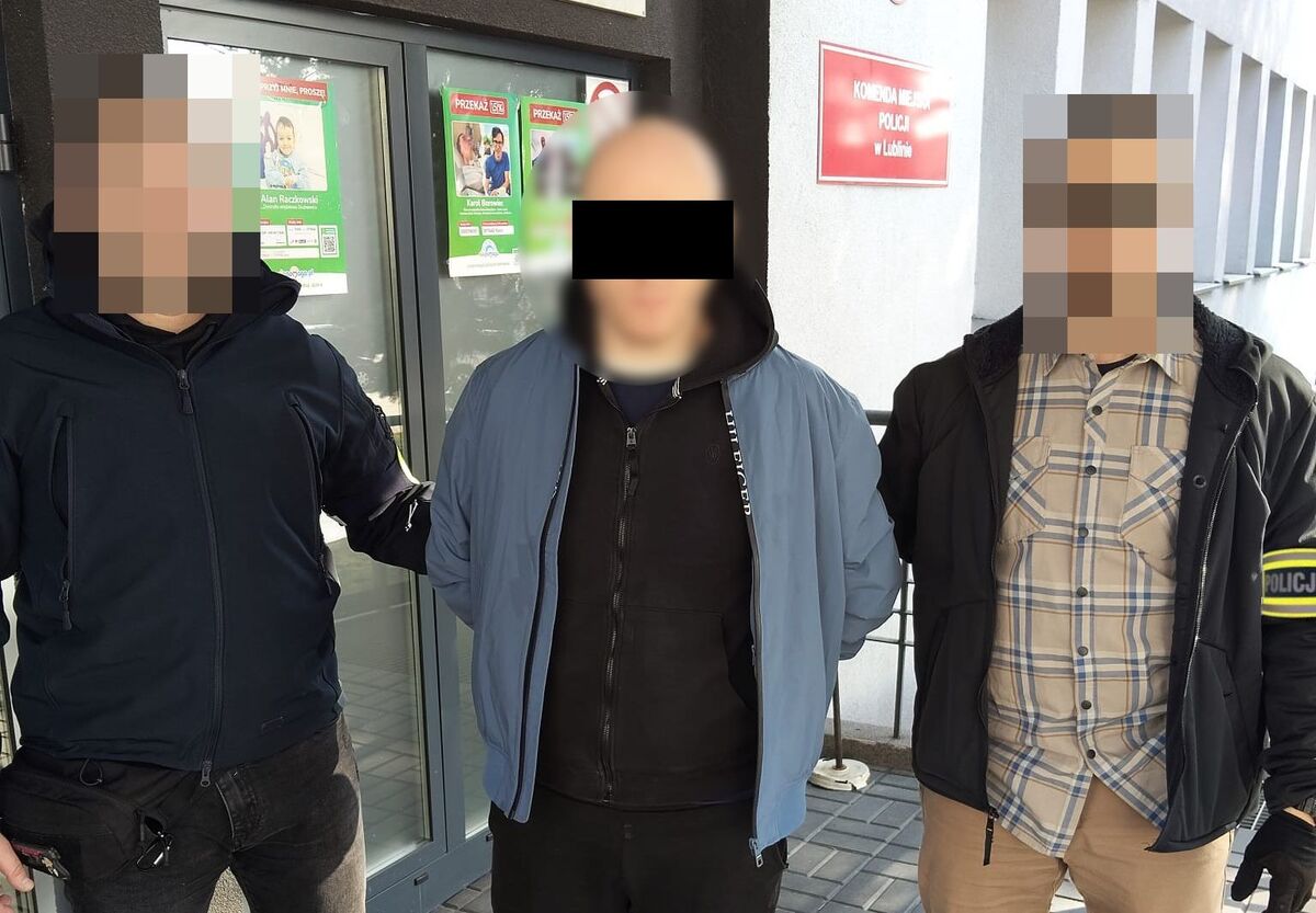 Policjanci prowadzą zatrzymanego mężczyznę.